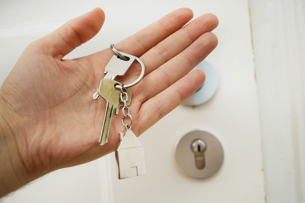 Hand holding keys to new house home inspections jacksonville fl