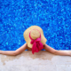 Woman with hat lounging in a blue tile pool home inspection jacksonville fl